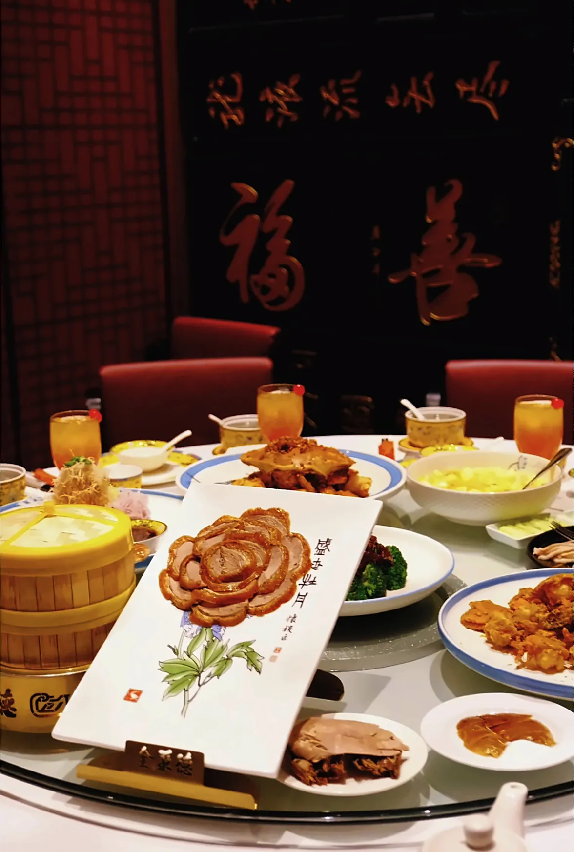 The Peony duck among shared dishes in a medium room